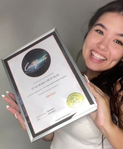 Woman smiling with her mystic star certificate